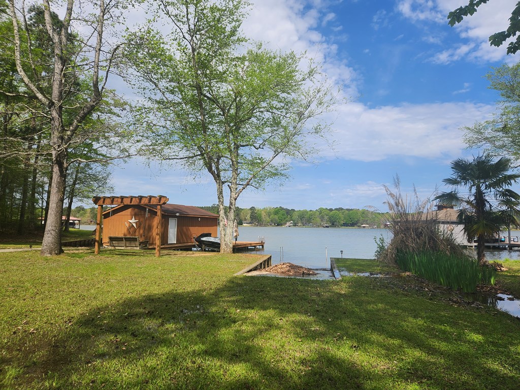 View of boat house, swing, and boat ramp